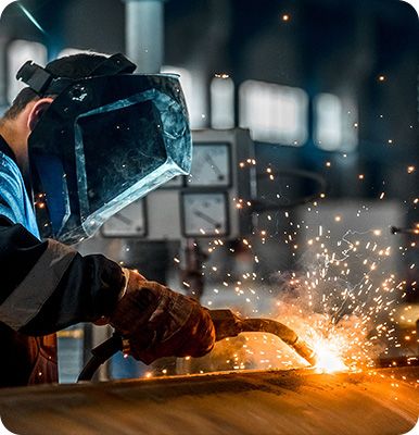 Factory workers are manufacturing equipment.